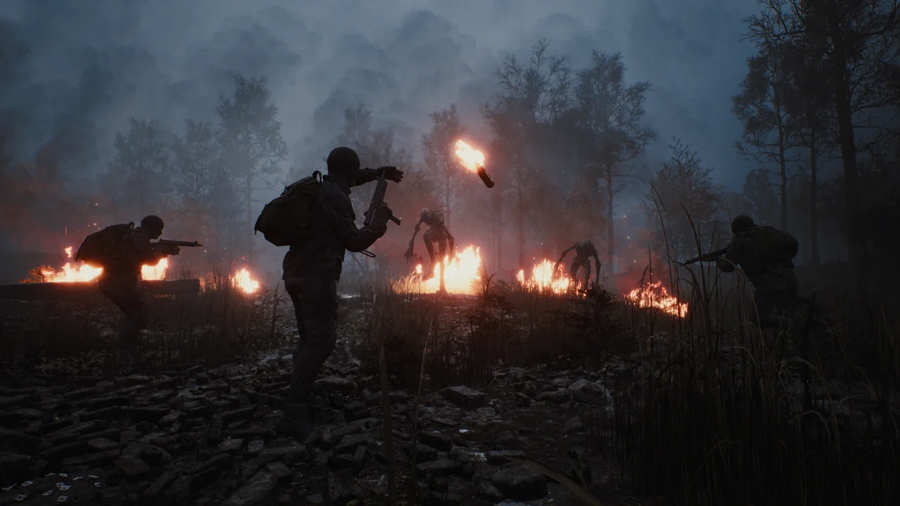 A squad fights creatures beside burning ground in a foggy forest