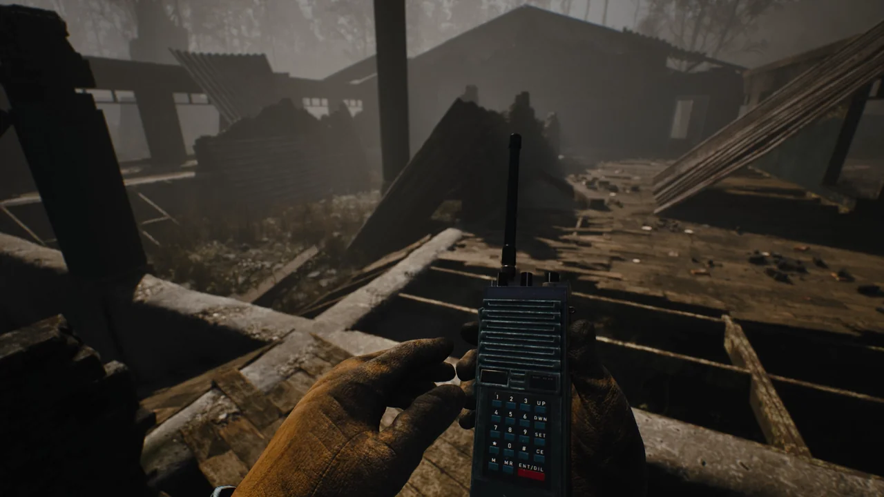 A survivor holds a handheld radio among collapsed beams inside a ruined building